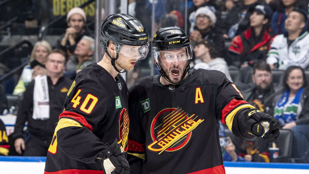 VANCOUVER, CANADA - DECEMBER 23: Elias Pettersson #40 and J.T. Miller #9 of the Vancouver Canucks discuss game play during the second period of their NHL game against the San Jose Sharks at Rogers Arena on December 23, 2024 in Vancouver, British Columbia, Canada.