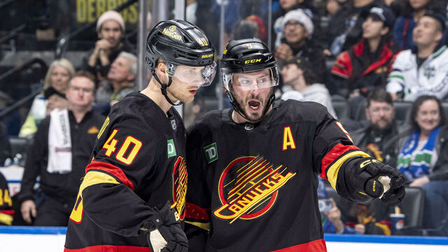 VANCOUVER, CANADA - DECEMBER 23: Elias Pettersson #40 and J.T. Miller #9 of the Vancouver Canucks discuss game play during the second period of their NHL game against the San Jose Sharks at Rogers Arena on December 23, 2024 in Vancouver, British Columbia, Canada.