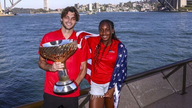 Team USA tennis players Taylor Fritz (L) and Coco Gauff pose with the United Cup Trophy in front of the Sydney Harbour Bridge during a media event in Sydney on January 6, 2025, after defeating Poland in the final of the United Cup tennis tournament on January 5.