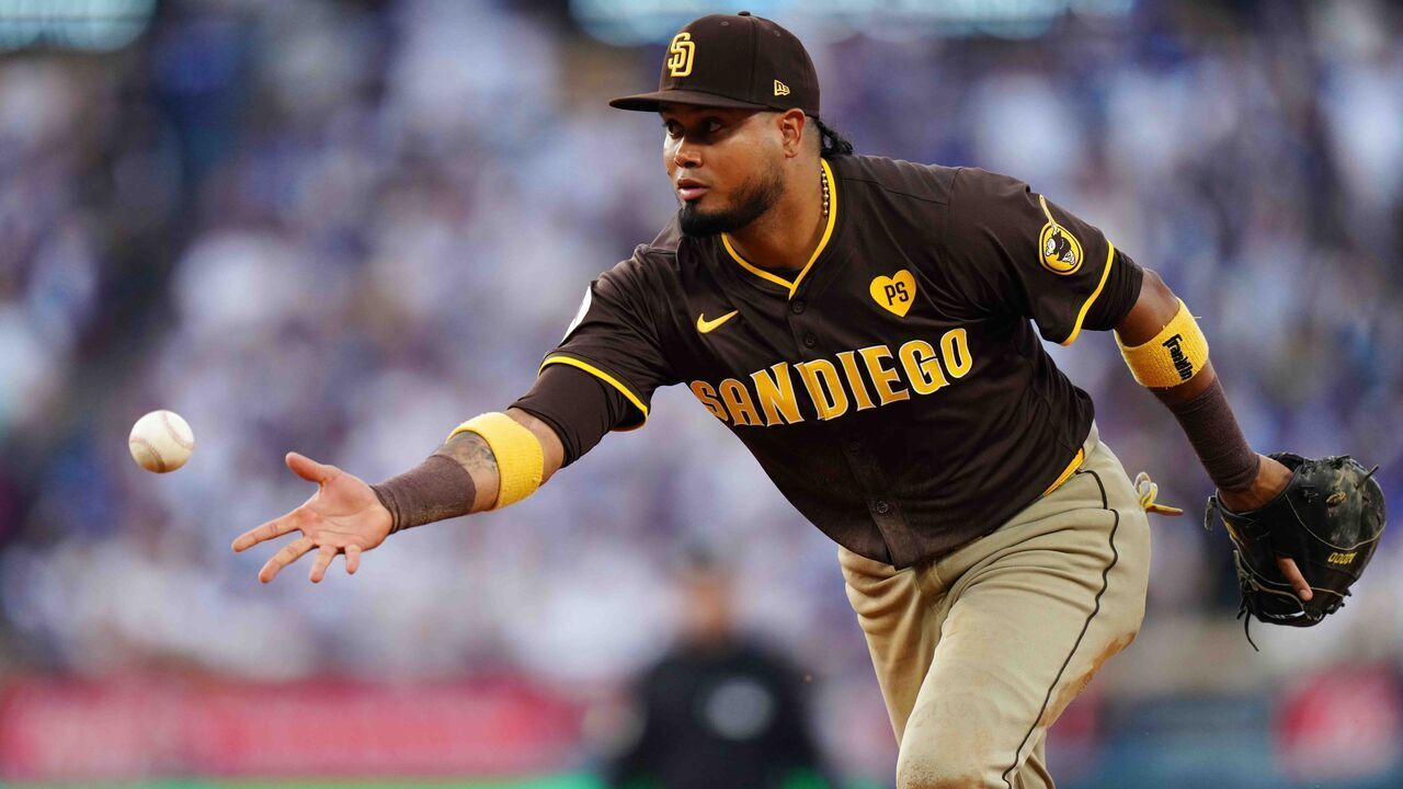 LOS ANGELES, CA - OCTOBER 11: Luis Arraez #4 of the San Diego Padres flips the ball for an out in the third inning during Game 5 of the Division Series presented by Booking.com between the San Diego Padres and the Los Angeles Dodgers at Dodger Stadium on Friday, October 11, 2024 in Los Angeles, California.