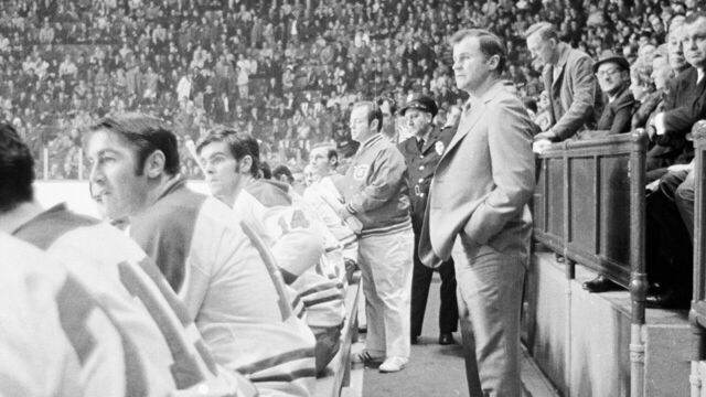 MONTREAL, CANADA - CIRCA 1970: Head Coach Al MacNeil of the New Montreal Canadiens follows the action from the bench at the Montreal Forum circa 1970 in Montreal, Quebec, Canada.