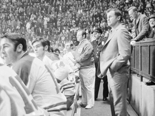 MONTREAL, CANADA - CIRCA 1970: Head Coach Al MacNeil of the New Montreal Canadiens follows the action from the bench at the Montreal Forum circa 1970 in Montreal, Quebec, Canada.