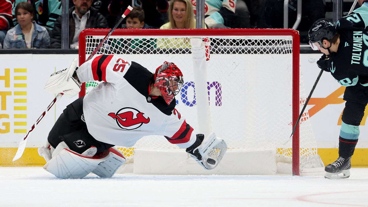 SEATTLE, WASHINGTON - JANUARY 06: Jacob Markstrom #25 of the New Jersey Devils makes a diving save against Eeli Tolvanen #20 of the Seattle Kraken during the third period at Climate Pledge Arena on January 06, 2025 in Seattle, Washington.