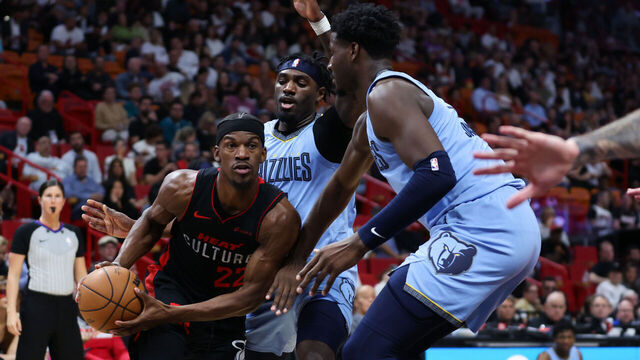 MIAMI, FLORIDA - JANUARY 24: Jimmy Butler #22 of the Miami Heat drives to the basket past Vince Williams Jr. #5 of the Memphis Grizzlies during the second quarter of the game at Kaseya Center on January 24, 2024 in Miami, Florida.