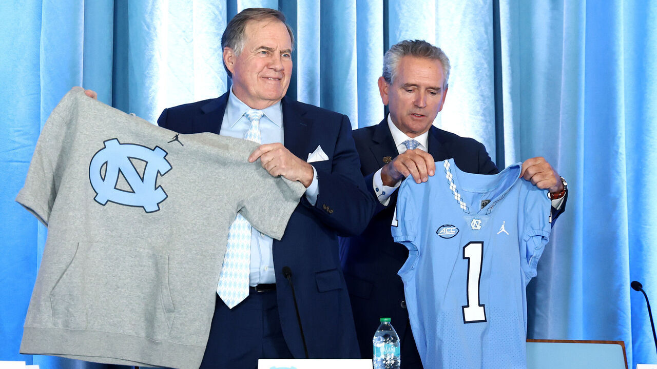 CHAPEL HILL, NORTH CAROLINA - DECEMBER 12: Head Coach Bill Belichick of the North Carolina Tar Heels poses with Athletic director Bubba Cunningham during a press conference on December 12, 2024 in Chapel Hill, North Carolina.