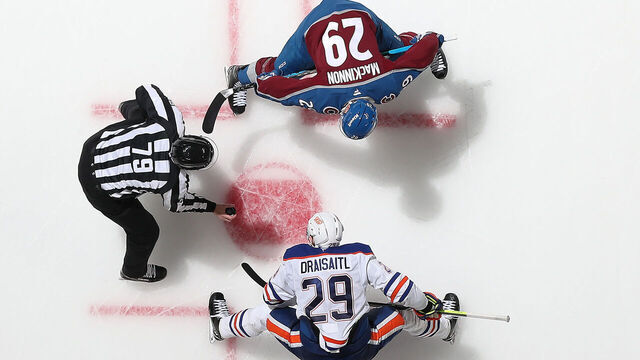 DENVER, COLORADO - NOVEMBER 30: Nathan MacKinnon #29 of the Colorado Avalanche faces off against Leon Draisaitl #29 of the Edmonton Oilers at Ball Arena on November 30, 2024 in Denver, Colorado.