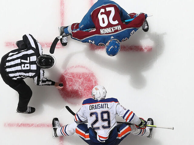 DENVER, COLORADO - NOVEMBER 30: Nathan MacKinnon #29 of the Colorado Avalanche faces off against Leon Draisaitl #29 of the Edmonton Oilers at Ball Arena on November 30, 2024 in Denver, Colorado.