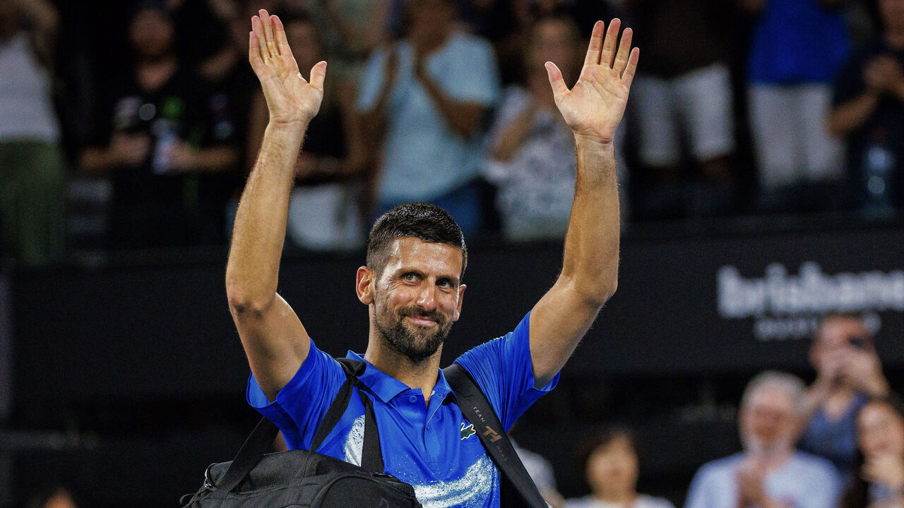 Serbia's Novak Djokovic acknowledges the fans as he walks off court following his defeat against USA's Reilly Opelka in their men's singles quarter-final match at the Brisbane International tennis tournament in Brisbane on January 3, 2025.