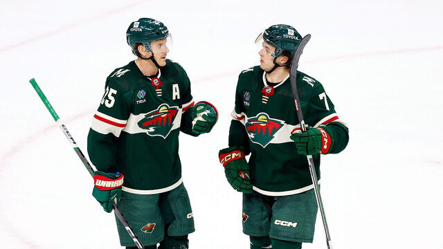 ST PAUL, MINNESOTA - FEBRUARY 19: Jonas Brodin #25 interacts with Brock Faber #7 of the Minnesota Wild in the third period against the Vancouver Canucks at Xcel Energy Center on February 19, 2024 in St Paul, Minnesota. The Wild defeated the Canucks 10-7.
