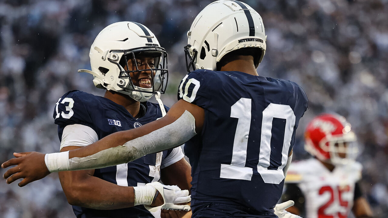 STATE COLLEGE, PA - NOVEMBER 12: Nicholas Singleton #10 of the Penn State Nittany Lions celebrates with Kaytron Allen #13 after scoring a touchdown against the Maryland Terrapins during the first half at Beaver Stadium on November 12, 2022 in State College, Pennsylvania.