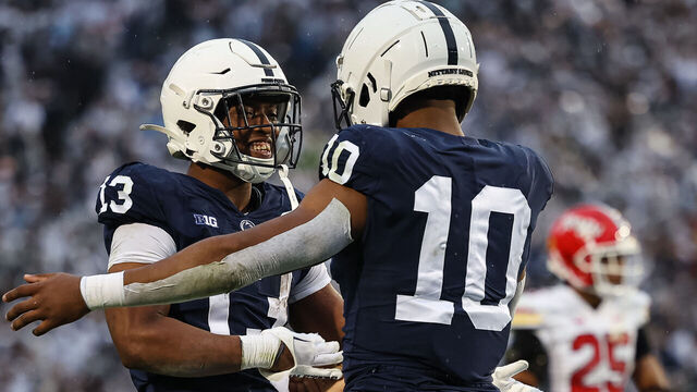 STATE COLLEGE, PA - NOVEMBER 12: Nicholas Singleton #10 of the Penn State Nittany Lions celebrates with Kaytron Allen #13 after scoring a touchdown against the Maryland Terrapins during the first half at Beaver Stadium on November 12, 2022 in State College, Pennsylvania.
