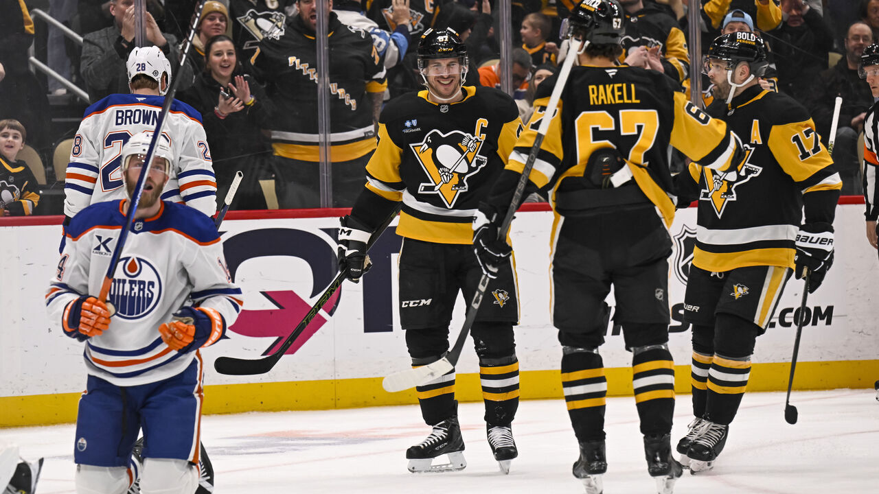 PITTSBURGH, PA - JANUARY 09: Pittsburgh Penguins center Sidney Crosby (87) celebrates his goal with right wing Rickard Rakell (67) and right wing Bryan Rust (17) during the second period in the NHL game between the Pittsburgh Penguins and the Edmonton Oilers on January 9, 2025, at PPG Paints Arena in Pittsburgh, PA.