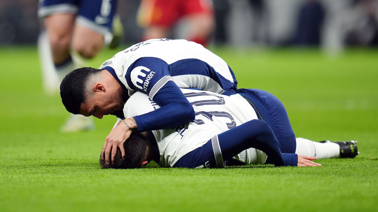Tottenham Hotspur's Pedro Porro checks on team-mate Rodrigo Bentancur as he lies on the ground during the Carabao Cup semi-final first leg match at the Tottenham Hotspur Stadium, London. Picture date: Wednesday January 8, 2025.