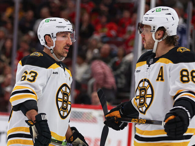 CHICAGO, IL - DECEMBER 04: Brad Marchand #63 of the Boston Bruins and David Pastrnak #88 of the Boston Bruins chat during the third period against the Chicago Blackhawks on December 4, 2024 at the United Center in Chicago, Illinois.