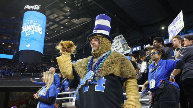 DETROIT, MI - JANUARY 05: A Detroit fan dressed in a lion costume cheers at the conclusion of a regular season NFL football game between the Minnesota Vikings and the Detroit Lions on January 5, 2025 at Ford Field in Detroit, Michigan.