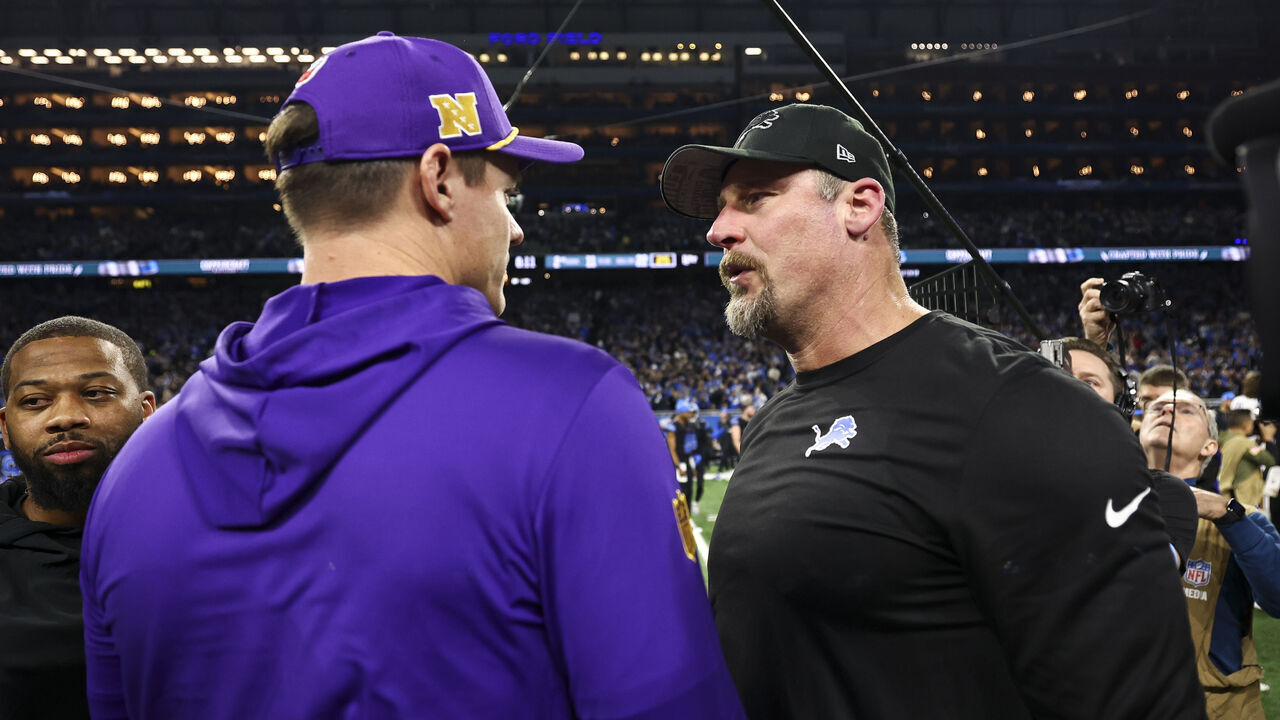 DETROIT, MICHIGAN - JANUARY 5: Head coach Dan Campbell of the Detroit Lions talks with head coach Kevin O'Connell of the Minnesota Vikings after an NFL football game at Ford Field on January 5, 2025 in Detroit, Michigan.
