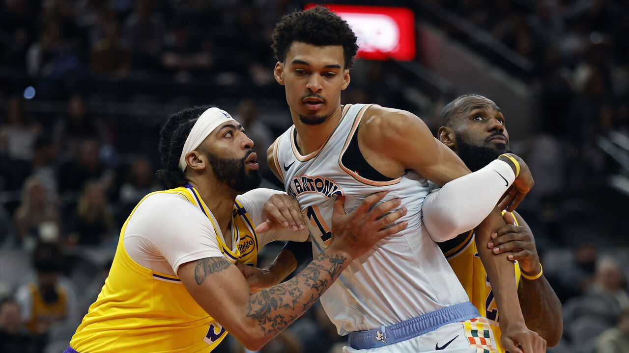 SAN ANTONIO, TEXAS - NOVEMBER 27: Victor Wembanyama #1 of the San Antonio Spurs blocks out Anthony Davis #3 and LeBron James #23 of the Los Angeles Lakers during the first quarter at Frost Bank Center on November 27, 2024 in San Antonio, Texas.