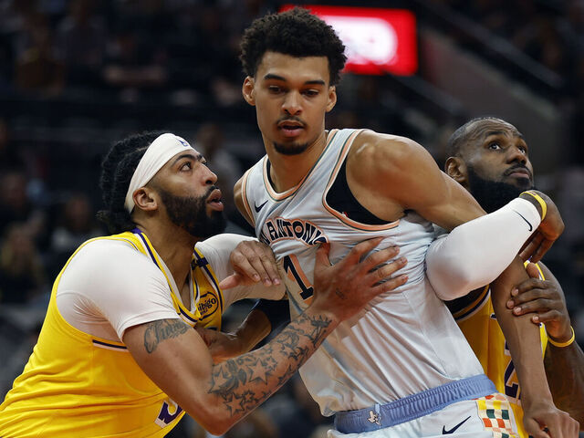SAN ANTONIO, TEXAS - NOVEMBER 27: Victor Wembanyama #1 of the San Antonio Spurs blocks out Anthony Davis #3 and LeBron James #23 of the Los Angeles Lakers during the first quarter at Frost Bank Center on November 27, 2024 in San Antonio, Texas.