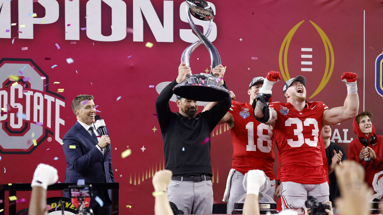 ARLINGTON, TEXAS - JANUARY 10: Head coach Ryan Day of the Ohio State Buckeyes hoists the Field Scovell Trophy after beating the Texas Longhorns 28-14 to win the Goodyear Cotton Bowl at AT&T Stadium on January 10, 2025 in Arlington, Texas.