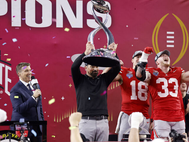 ARLINGTON, TEXAS - JANUARY 10: Head coach Ryan Day of the Ohio State Buckeyes hoists the Field Scovell Trophy after beating the Texas Longhorns 28-14 to win the Goodyear Cotton Bowl at AT&T Stadium on January 10, 2025 in Arlington, Texas.