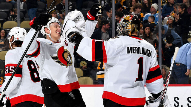 PITTSBURGH, PA - JANUARY 11: Leevi Merilainen #1 celebrates with Brady Tkachuk #7 of the Ottawa Senators after defeating the Pittsburgh Penguins at PPG PAINTS Arena on January11, 2025 in Pittsburgh, Pennsylvania.