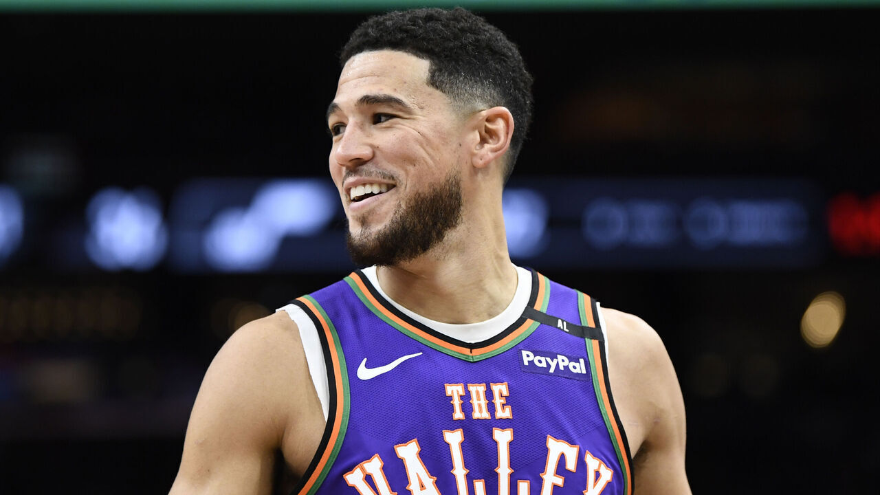 PHOENIX, ARIZONA - JANUARY 11: Devin Booker #1 of the Phoenix Suns looks on during the first half of the NBA game against the Utah Jazz at Footprint Center on January 11, 2025 in Phoenix, Arizona.