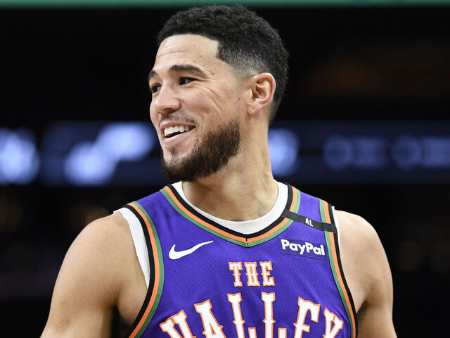 PHOENIX, ARIZONA - JANUARY 11: Devin Booker #1 of the Phoenix Suns looks on during the first half of the NBA game against the Utah Jazz at Footprint Center on January 11, 2025 in Phoenix, Arizona.