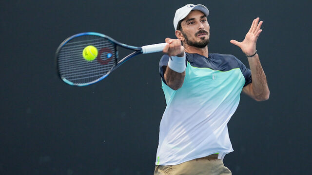 MELBOURNE, AUSTRALIA - JANUARY 12: Hady Habib of Lebanon plays a forehand in the Men's Singles First Round match against Yunchaokete Bu of China during day one of the 2025 Australian Open at Melbourne Park on January 12, 2025 in Melbourne, Australia.