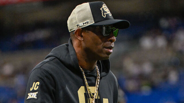 SAN ANTONIO, TX - DECEMBER 28: Colorado Buffaloes head coach Deion Sanders revs up players during pregame warmups before the football game between the BYU Cougars and Colorado Buffaloes on December 28, 2024, at the Alamodome in San Antonio, Texas.