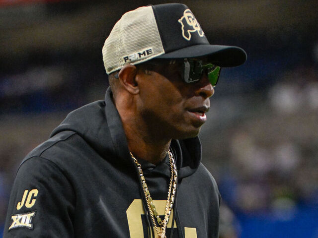 SAN ANTONIO, TX - DECEMBER 28: Colorado Buffaloes head coach Deion Sanders revs up players during pregame warmups before the football game between the BYU Cougars and Colorado Buffaloes on December 28, 2024, at the Alamodome in San Antonio, Texas.