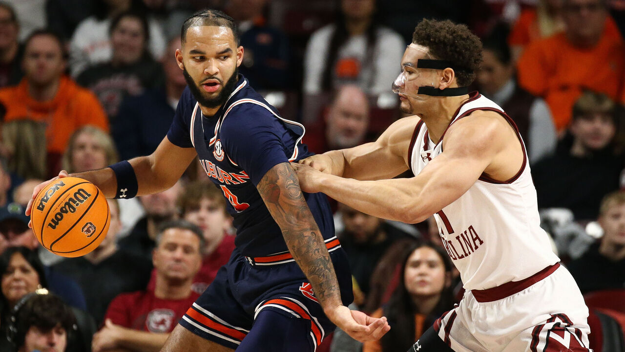 COLUMBIA, SOUTH CAROLINA - JANUARY 11: Johni Broome #4 of the Auburn Tigers moves the ball against Benjamin Bosmans-Verdonk #31 of the South Carolina Gamecocks during the first half at Colonial Life Arena on January 11, 2025 in Columbia, South Carolina.