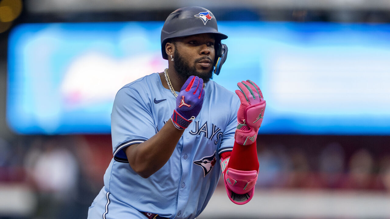 TORONTO, CANADA - AUGUST 19: Vladimir Guerrero Jr. #27 of the Toronto Blue Jays celebrates after hitting a home run against the Cincinnati Reds during the first inning in their MLB game at Rogers Centre on August 19, 2024 in Toronto, Canada.
