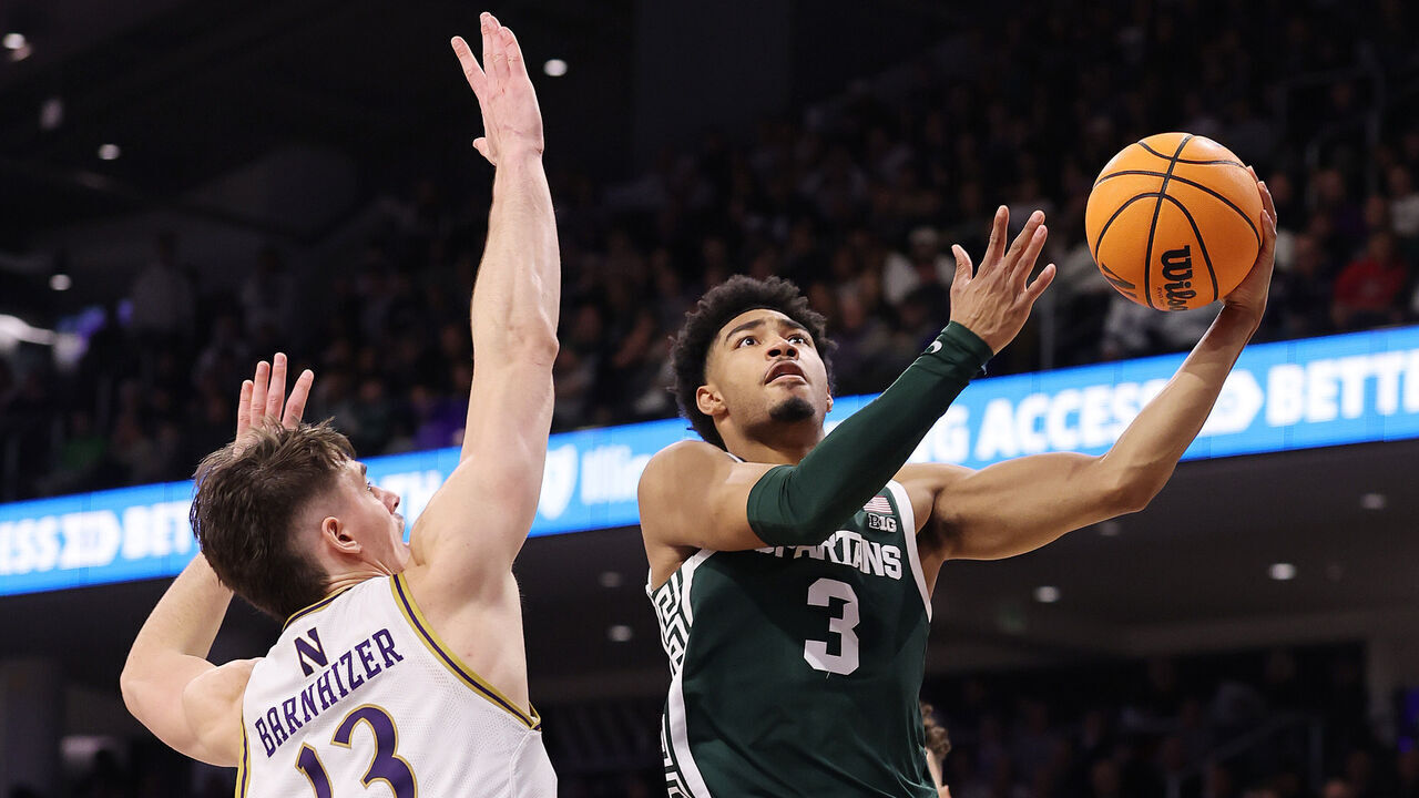 EVANSTON, ILLINOIS - JANUARY 12: Jaden Akins #3 of the Michigan State Spartans goes up for a layup against Brooks Barnhizer #13 of the Northwestern Wildcats during the second half at Welsh-Ryan Arena on January 12, 2025 in Evanston, Illinois.