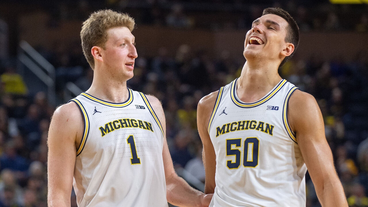 ANN ARBOR, MICHIGAN - JANUARY 12: Danny Wolf #1 (L) and Vladislav Goldin #50 of the Michigan Wolverines chat on the court during a break in the action of the second half of a college basketball game against the Washington Huskies at Crisler Arena on January 12, 2025 in Ann Arbor, Michigan. The Michigan Wolverines won the game 91-75.
