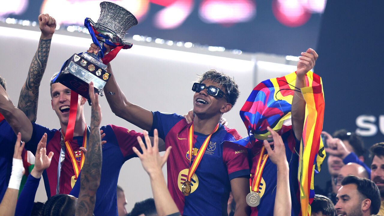 JEDDAH, SAUDI ARABIA - JANUARY 12: Lamine Yamal of FC Barcelona celebrates with the Supercopa de Espana trophy during the trophy presentation after the Spanish Super Cup Final between Real Madrid and FC Barcelona at King Abdullah Sports City on January 12, 2025 in Jeddah, Saudi Arabia.