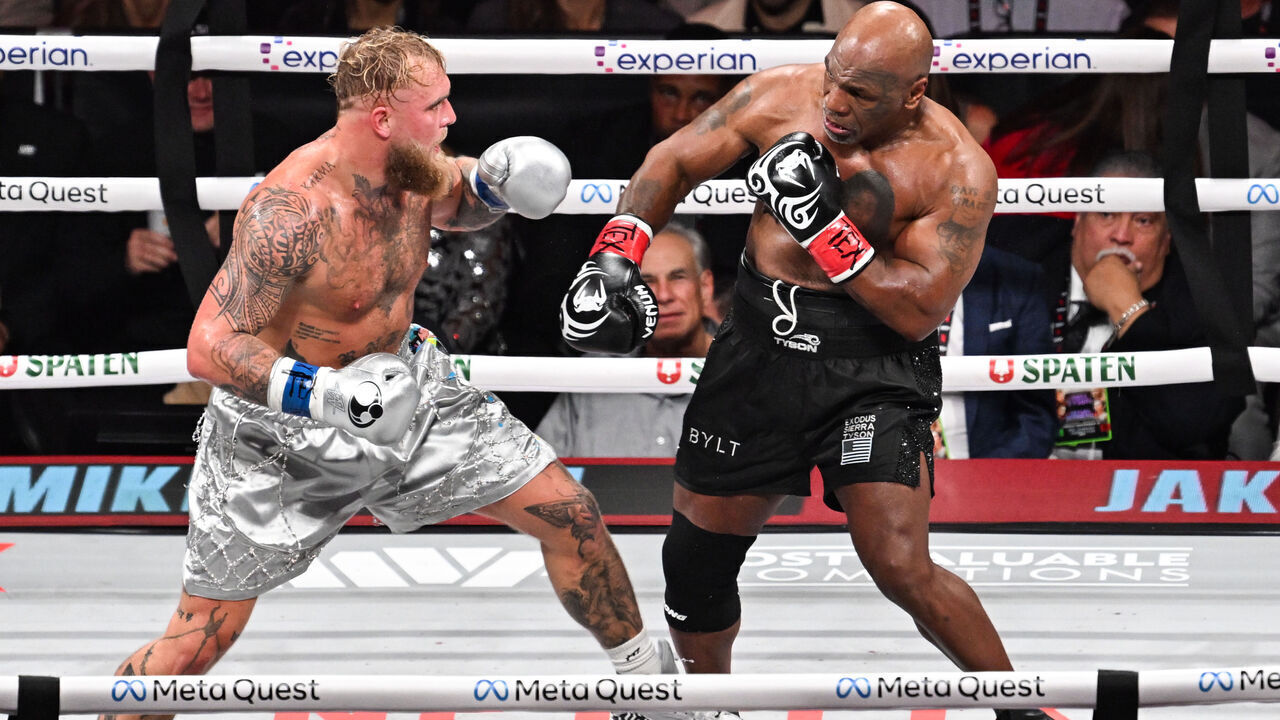 ARLINGTON, TEXAS - NOVEMBER 15: Mike Tyson (in black short) and Jake Paul (in silver short) exchange punches during their heavyweight world titles of the Premiere Boxing Championship on Friday night at AT&T Stadium in Arlington, Texas, United States on November 15, 2024.