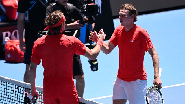 USA's Alex Michelsen (R) is congratulated by Greece's Stefanos Tsitsipas after his victory in their men's singles match on day two of the Australian Open tennis tournament in Melbourne on January 13, 2025.