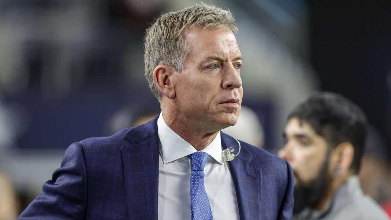 ARLINGTON, TX - DECEMBER 09: ESPN football broadcaster Troy Aikman visits the sidelines before the game between the Dallas Cowboys and the Cincinnati Bengals on December 9, 2024 at AT&T Stadium in Arlington, Texas.