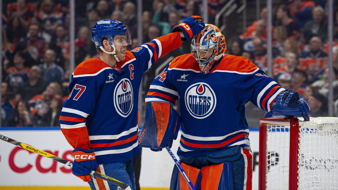 EDMONTON, ALBERTA - JANUARY 13: Connor McDavid #97 taps the head of Stuart Skinner #74 of the Edmonton Oilers during the first period against the Los Angeles Kings at Rogers Place on January 13, 2025 in Edmonton, Alberta, Canada.