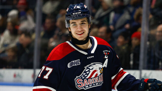 SAGINAW, MI - DECEMBER 29: Michael Misa #77 of Saginaw has a laugh with a teammate during a game between Niagara Ice Dogs and Saginaw Spirit at Dow Event Center on December 29, 2024 in Saginaw, Michigan.
