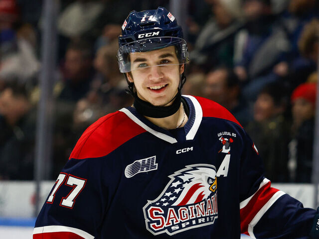 SAGINAW, MI - DECEMBER 29: Michael Misa #77 of Saginaw has a laugh with a teammate during a game between Niagara Ice Dogs and Saginaw Spirit at Dow Event Center on December 29, 2024 in Saginaw, Michigan.