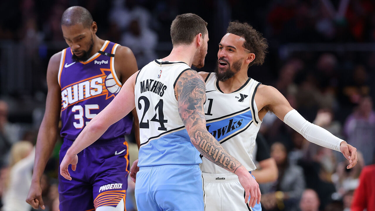 ATLANTA, GEORGIA - JANUARY 14: Garrison Mathews #24 of the Atlanta Hawks reacts with Trae Young #11 after hitting a three-point basket against the Phoenix Suns during the fourth quarter at State Farm Arena on January 14, 2025 in Atlanta, Georgia. NOTE TO USER: User expressly acknowledges and agrees that, by downloading and/or using this photograph, user is consenting to the terms and conditions of the Getty Images License Agreement.
