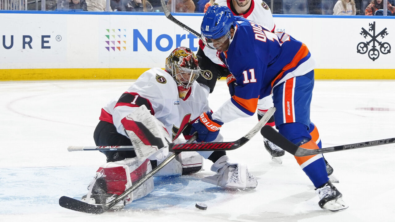 ELMONT, NEW YORK - JANUARY 14: Leevi Merilainen #1 of the Ottawa Senators makes a save against Anthony Duclair #11 of the New York Islanders during the third period at UBS Arena on January 14, 2025 in Elmont, New York.