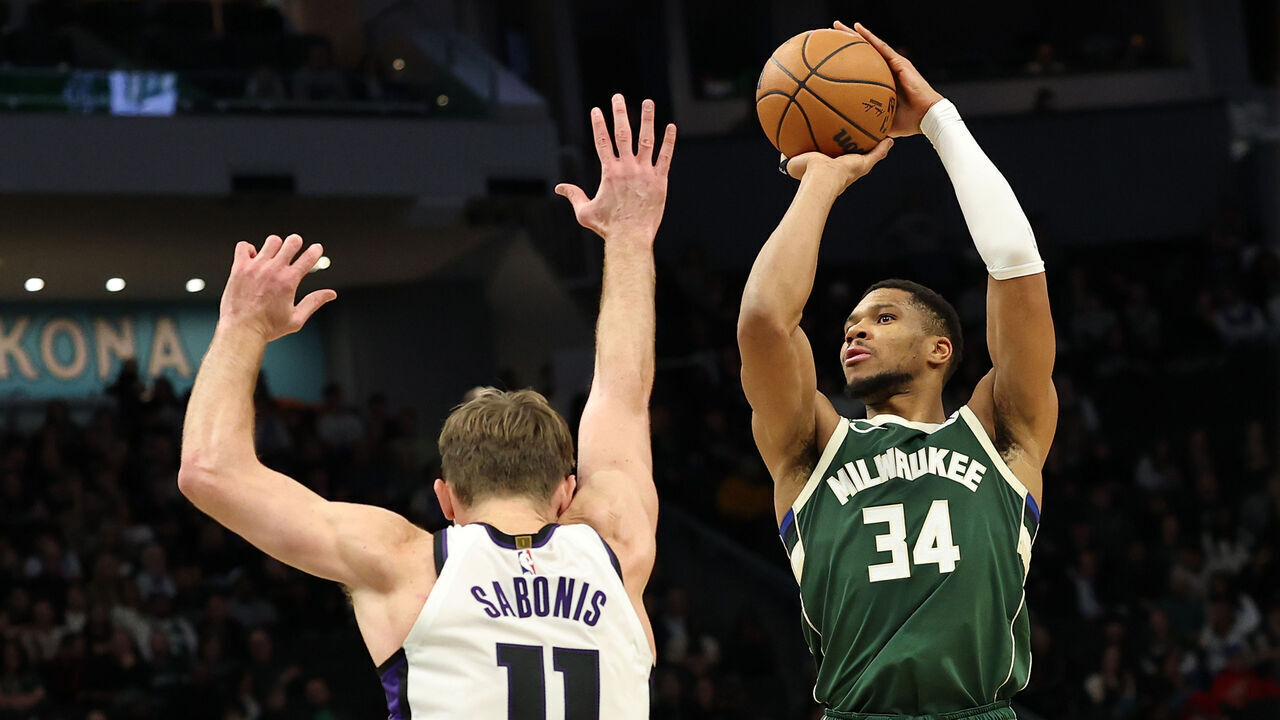 MILWAUKEE, WISCONSIN - JANUARY 14: Giannis Antetokounmpo #34 of the Milwaukee Bucks is defended by Domantas Sabonis #11 of the Sacramento Kings during the first half of a game at Fiserv Forum on January 14, 2025 in Milwaukee, Wisconsin.
