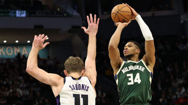 MILWAUKEE, WISCONSIN - JANUARY 14: Giannis Antetokounmpo #34 of the Milwaukee Bucks is defended by Domantas Sabonis #11 of the Sacramento Kings during the first half of a game at Fiserv Forum on January 14, 2025 in Milwaukee, Wisconsin.