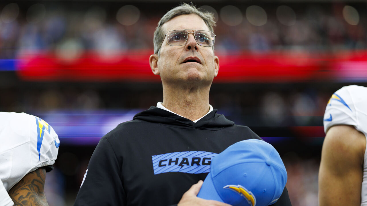 HOUSTON, TEXAS - JANUARY 11: Head coach Jim Harbaugh of the Los Angeles Chargers stands on the sidelines during the national anthem prior to an AFC Wild Card game against the Houston Texans, at NRG Stadium on January 11, 2025 in Houston, Texas.
