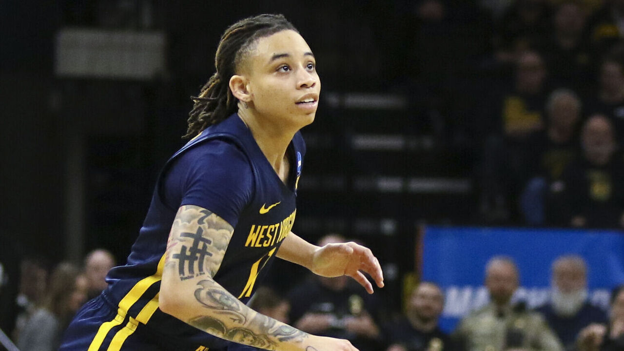 IOWA CITY, IOWA- MARCH 25: Guard J.J. Quinerly #11 of the West Virginia Mountaineers goes after the ball in the second half against the Iowa Hawkeyes during their second round match-up in the 2024 NCAA Division 1 Womens Basketball Championship at Carver-Hawkeye Arena on March 25, 2024 in Iowa City, Iowa.