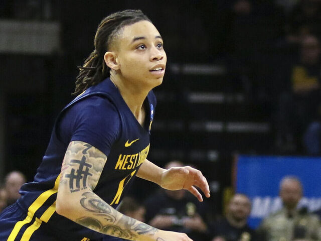 IOWA CITY, IOWA- MARCH 25: Guard J.J. Quinerly #11 of the West Virginia Mountaineers goes after the ball in the second half against the Iowa Hawkeyes during their second round match-up in the 2024 NCAA Division 1 Womens Basketball Championship at Carver-Hawkeye Arena on March 25, 2024 in Iowa City, Iowa.