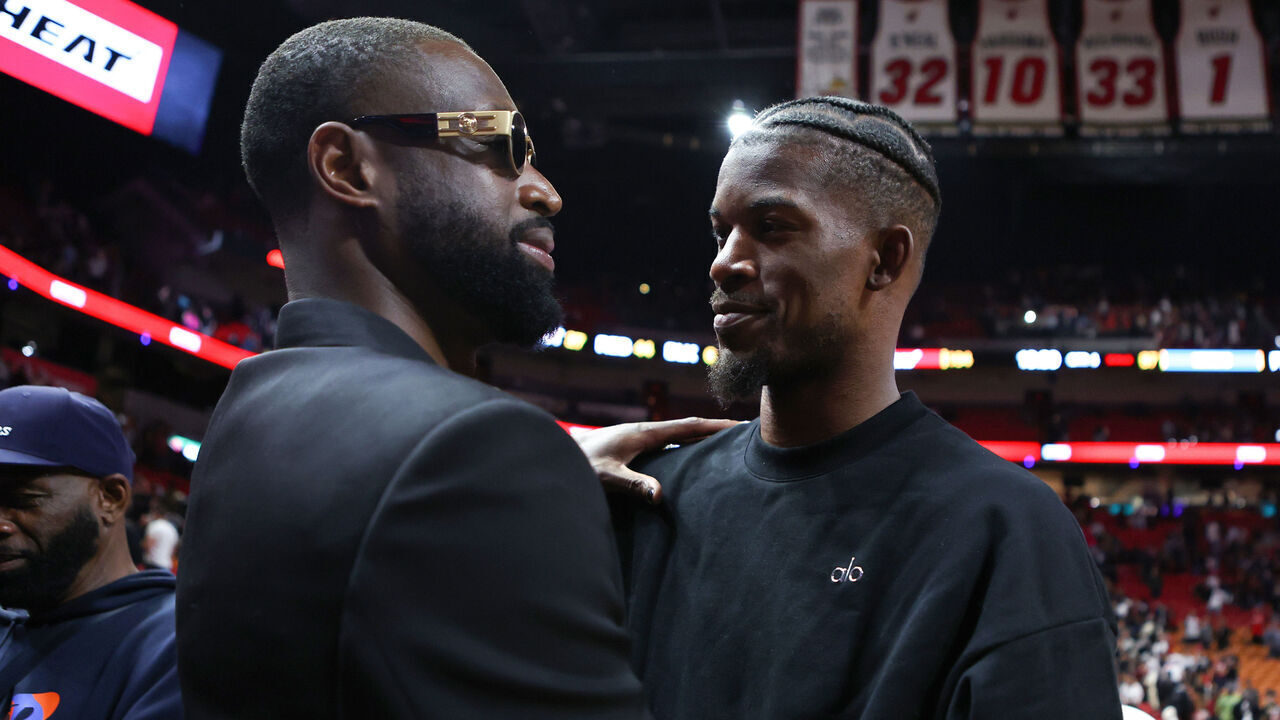 MIAMI, FLORIDA - JANUARY 14: Former Miami Heat player Dwayne Wade and Jimmy Butler #22 of the Miami Heat embrace on the court after a game against the Charlotte Hornets at Kaseya Center on January 14, 2024 in Miami, Florida.