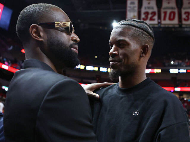 MIAMI, FLORIDA - JANUARY 14: Former Miami Heat player Dwayne Wade and Jimmy Butler #22 of the Miami Heat embrace on the court after a game against the Charlotte Hornets at Kaseya Center on January 14, 2024 in Miami, Florida.